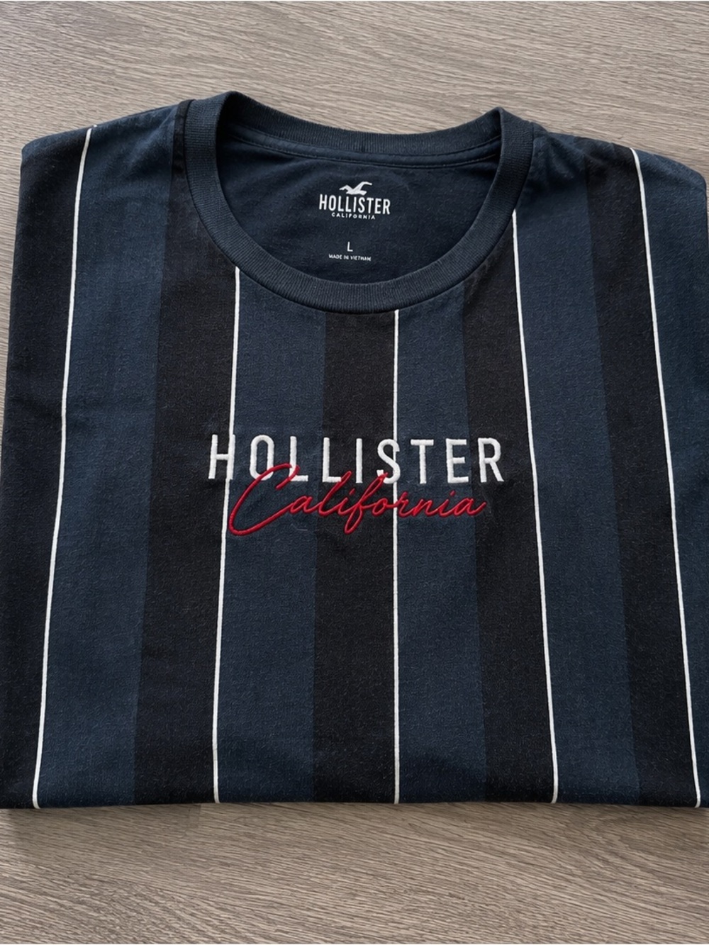 Hollister Navy and Black Vertical Stripe Logo Tee with Red Script